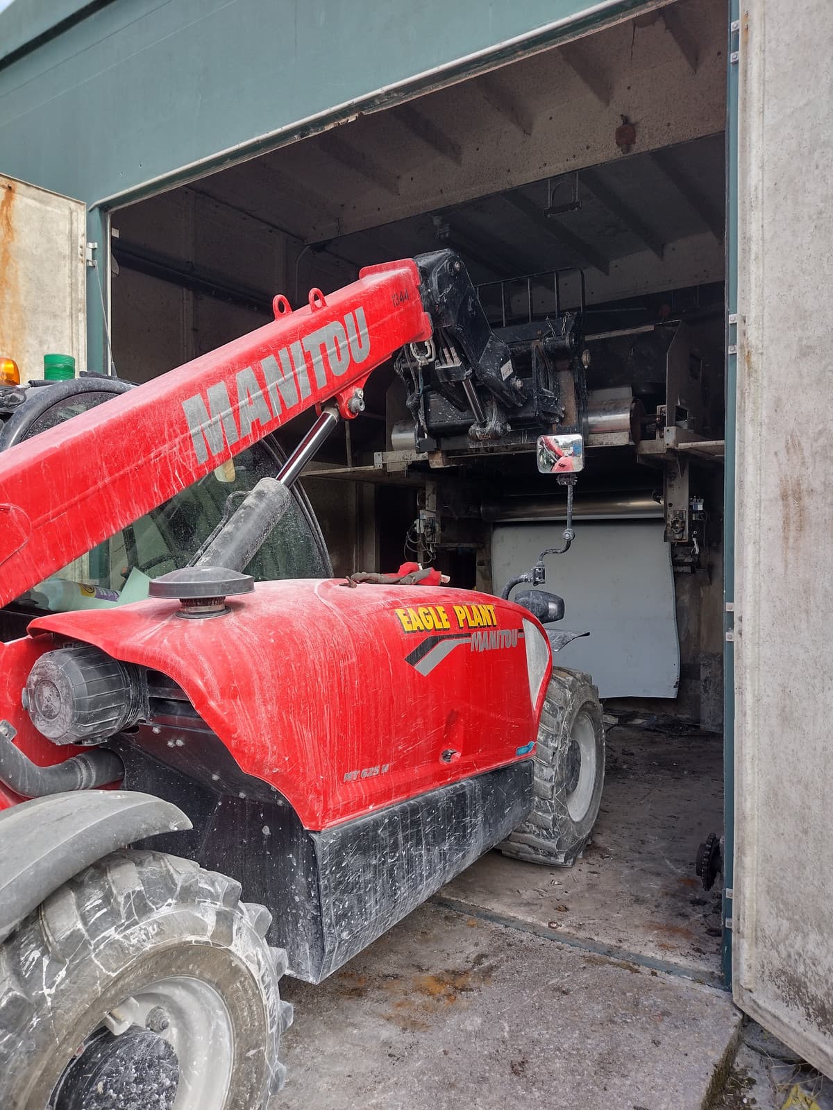 Telehandler extracting redundant plant through a building doorway