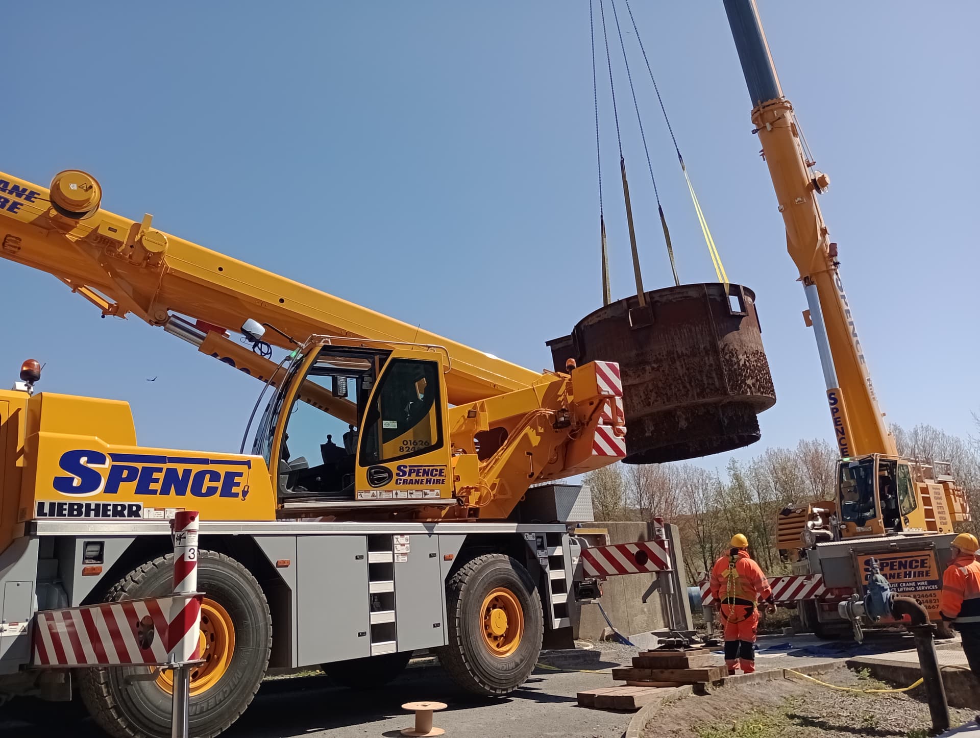 Twin crane lift removing a redundant steel tank during asset decommissioning